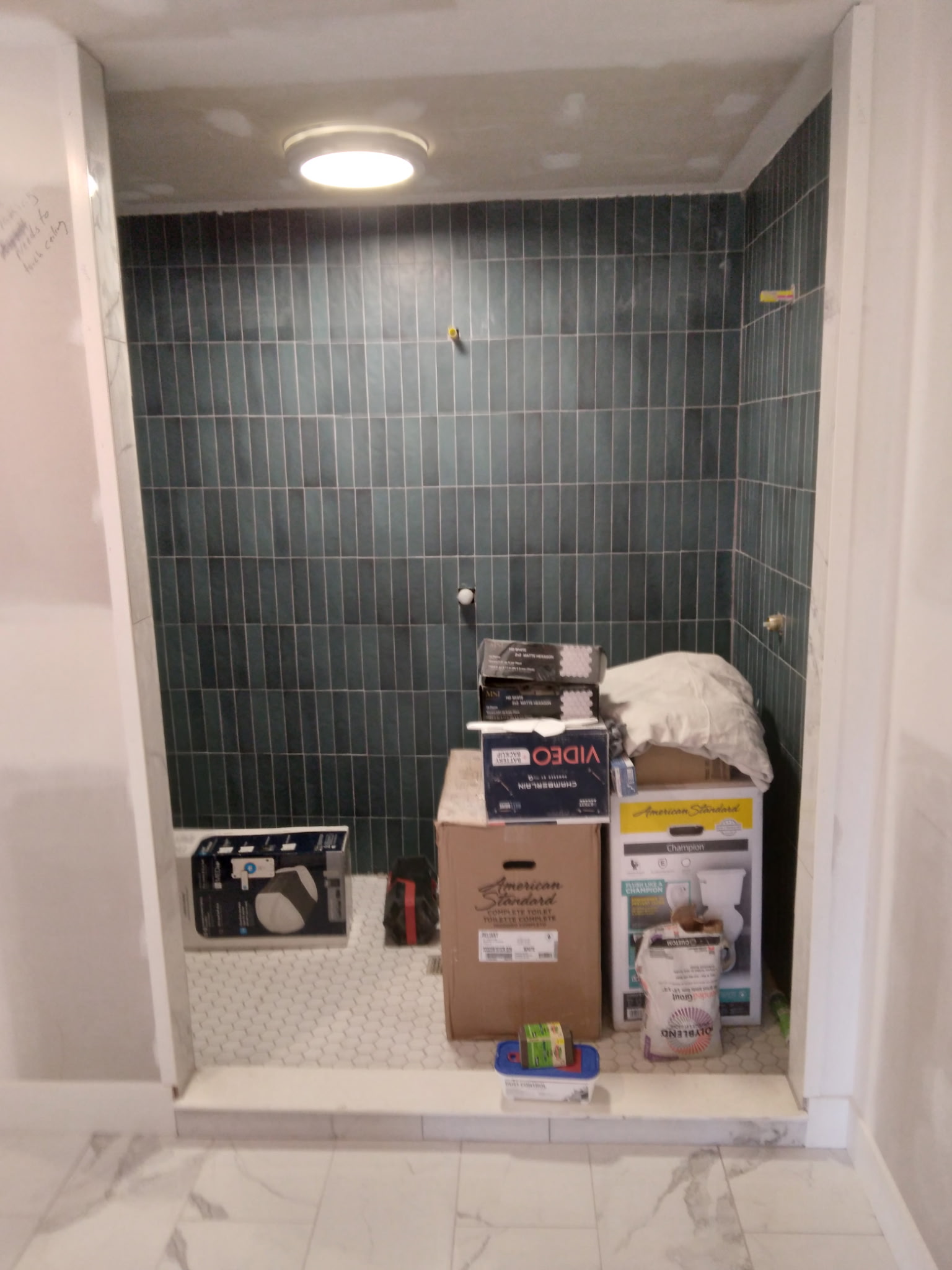 Shower with green subway tile & hex floor tile