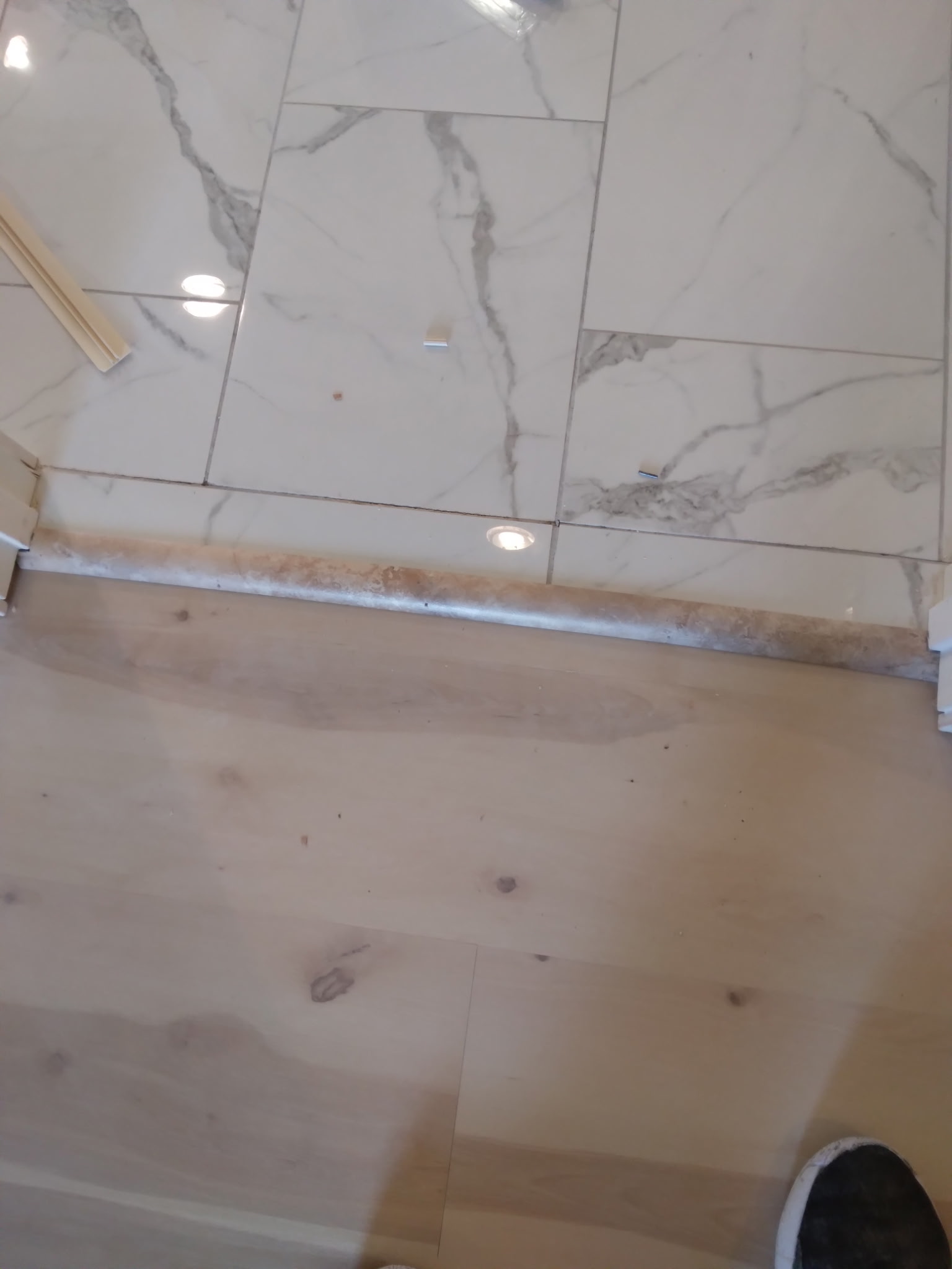 Russ's flooring work — marble tile meets hardwood