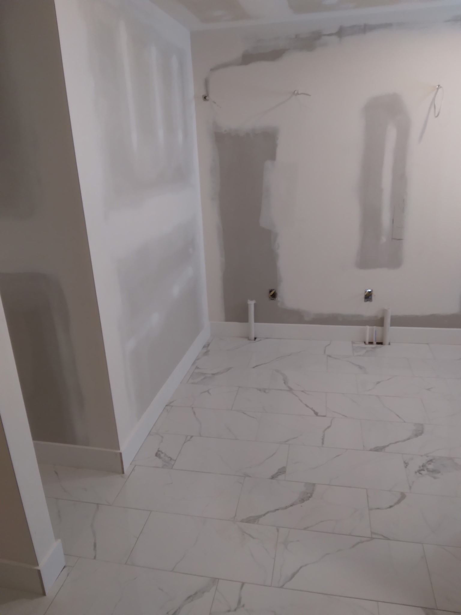 Bathroom tile floor & unfinished walls