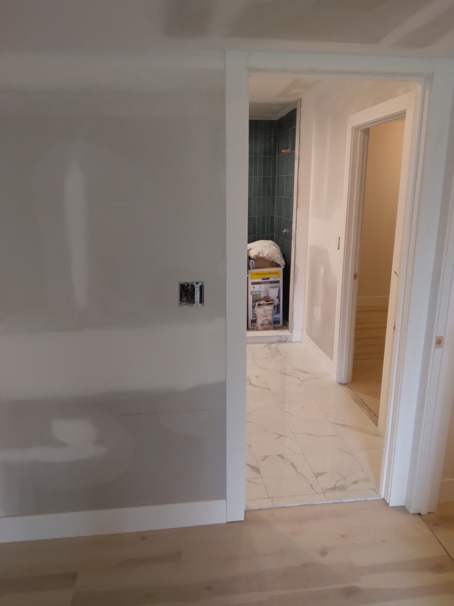 Bathroom with green shower tile & marble floor